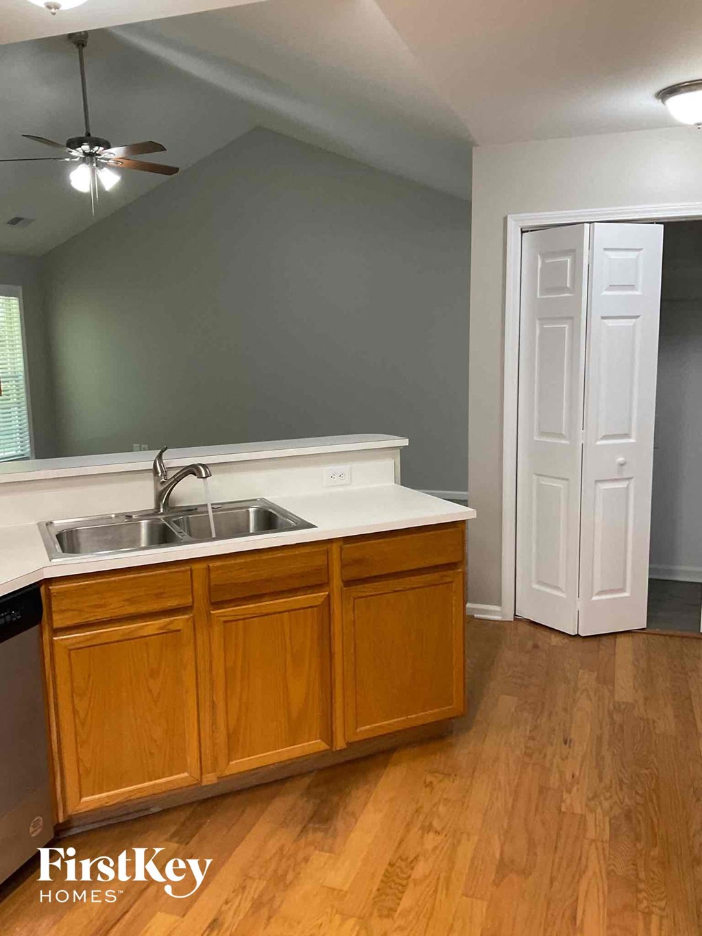 an empty kitchen with a sink and a white door