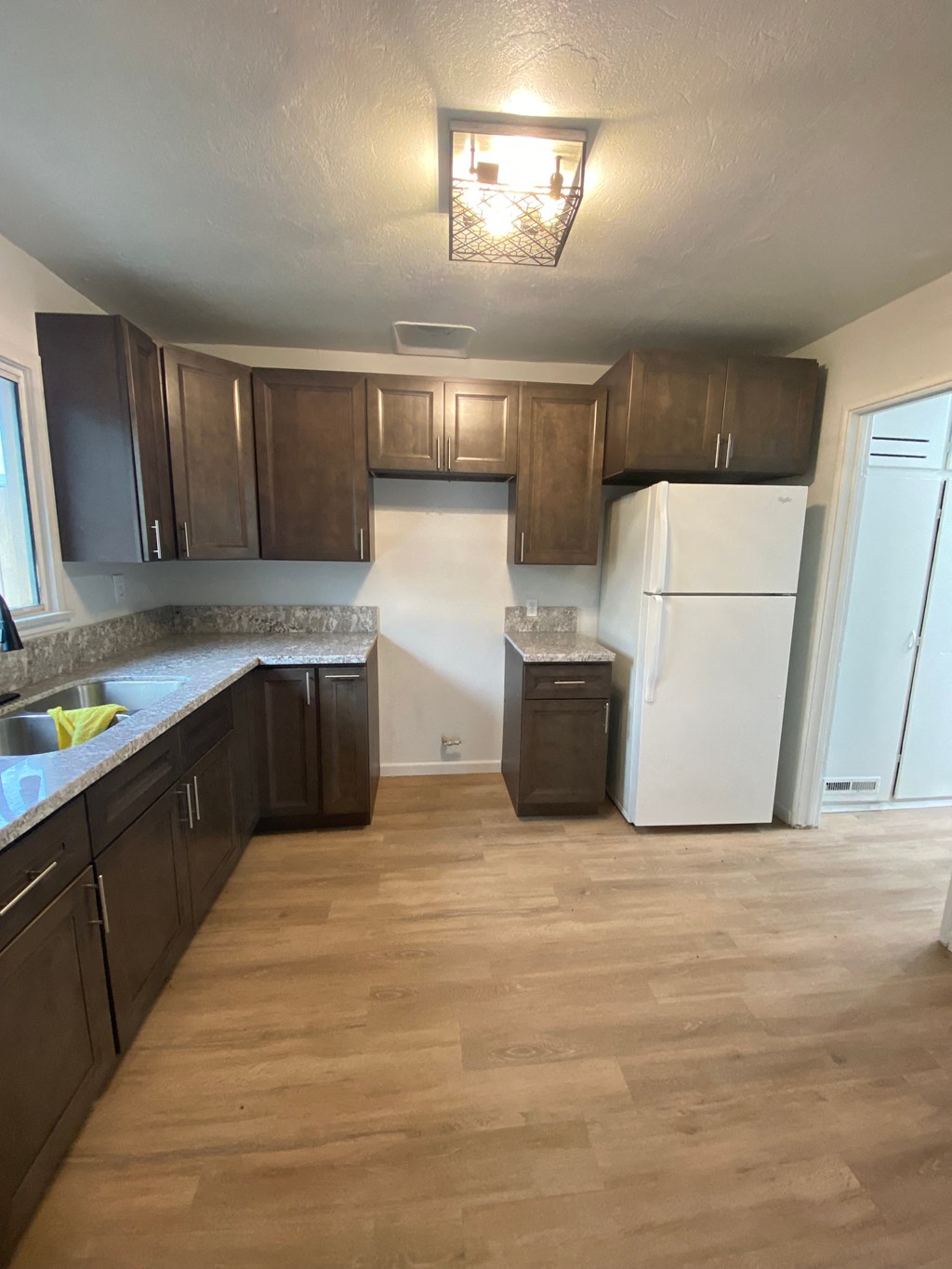 a kitchen with wooden cabinets and a white refrigerator