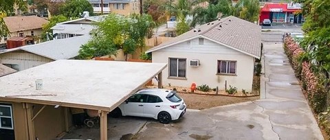 a white car parked in front of a house