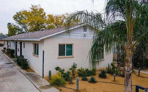 a white house with a palm tree in front of it