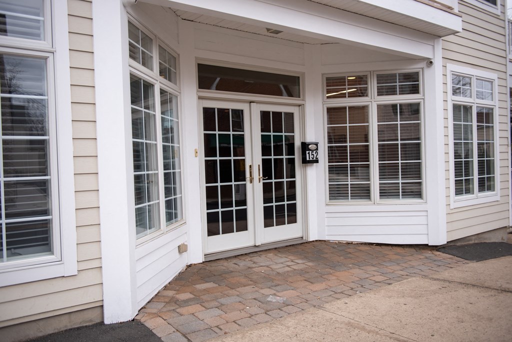 the front entrance of a house with doors and windows