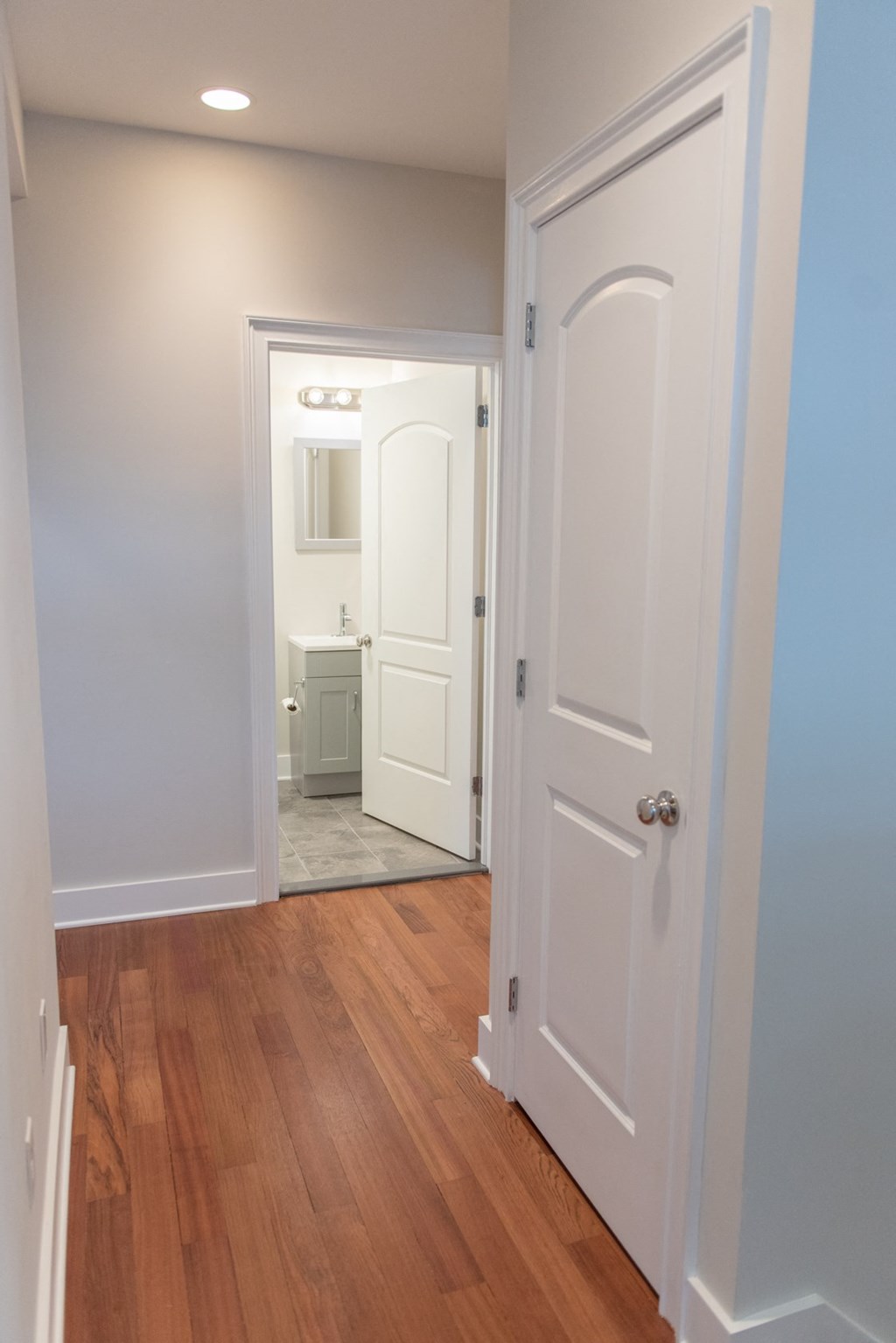 the view from the closet into the bathroom with the door open