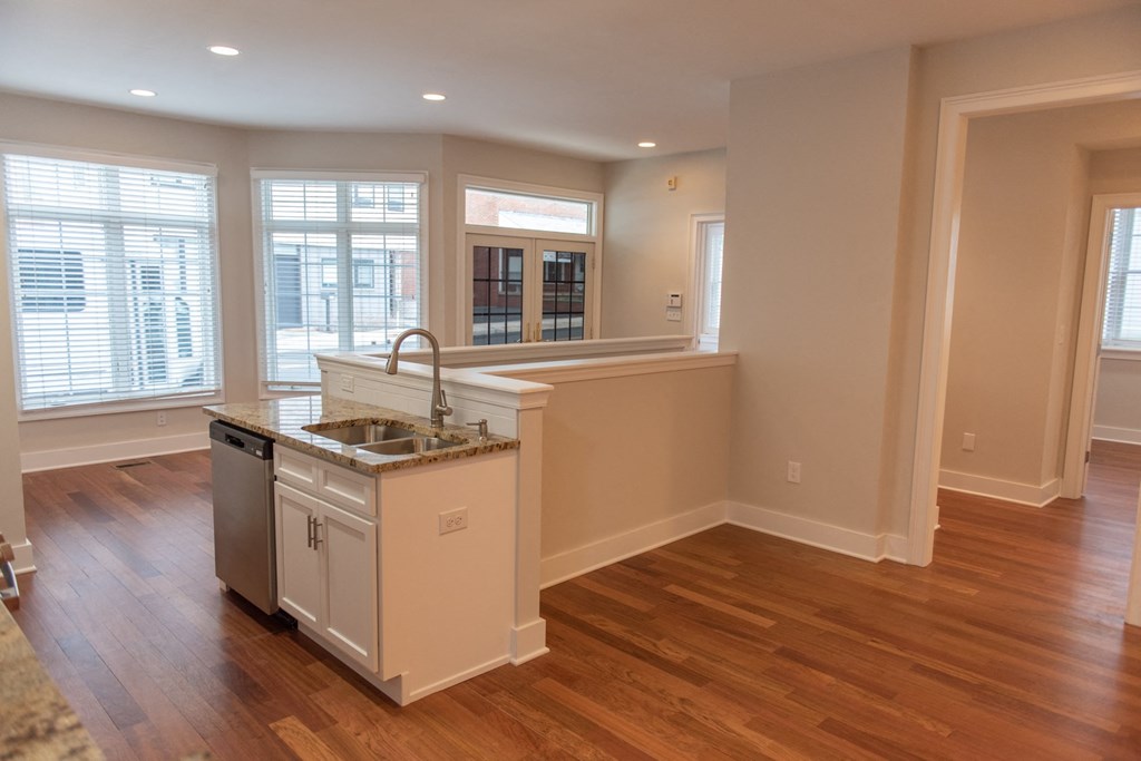 an empty kitchen with an island in the middle of it