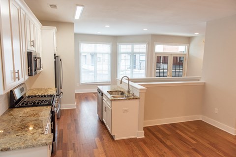 a kitchen with a sink and a stove and a window