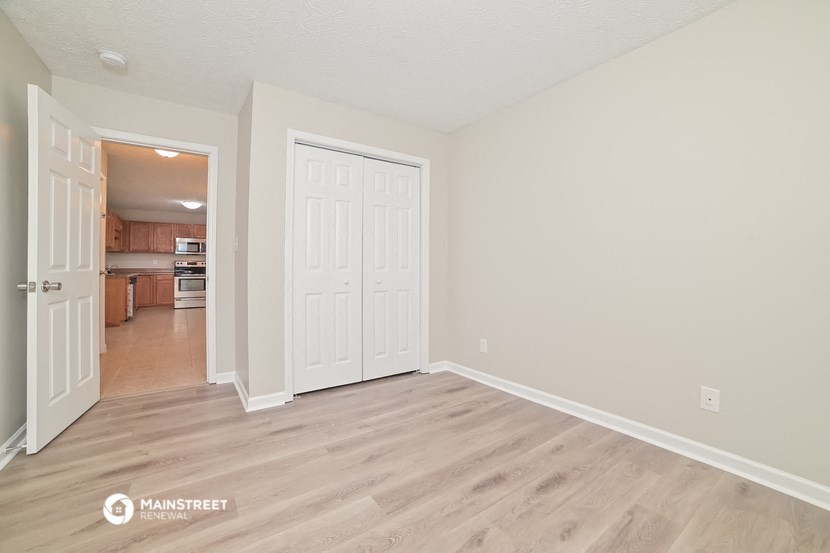 the living room and kitchen of a renovated