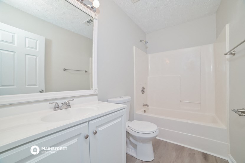 a bathroom with a sink toilet and a bath tub