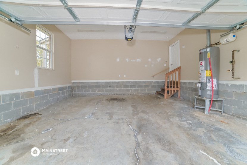an empty garage with a concrete floor and a window