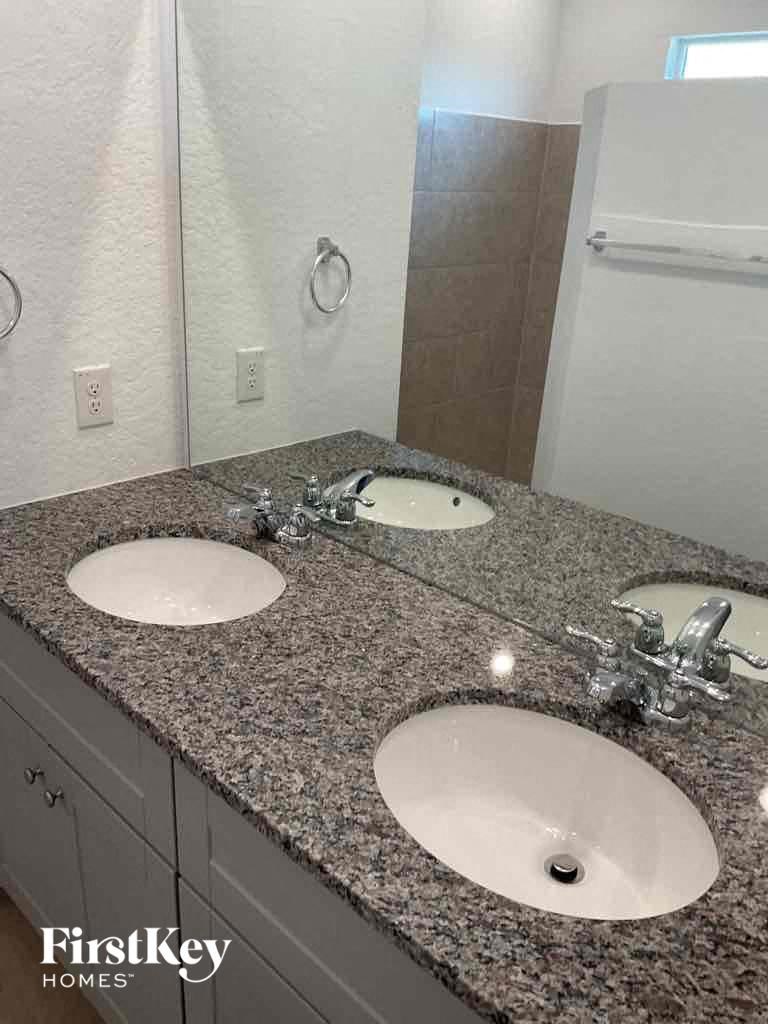 a bathroom with two sinks and a mirror