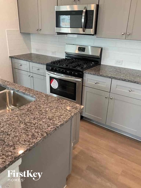 a kitchen with granite counter tops and stainless steel appliances