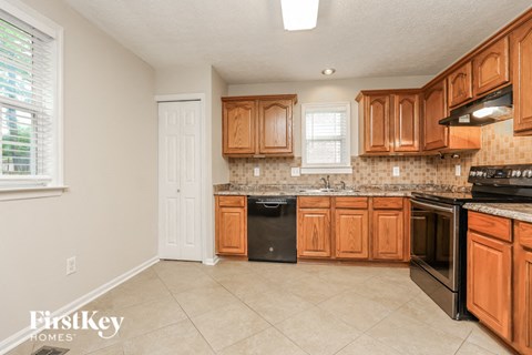 a kitchen with wooden cabinets and black appliances