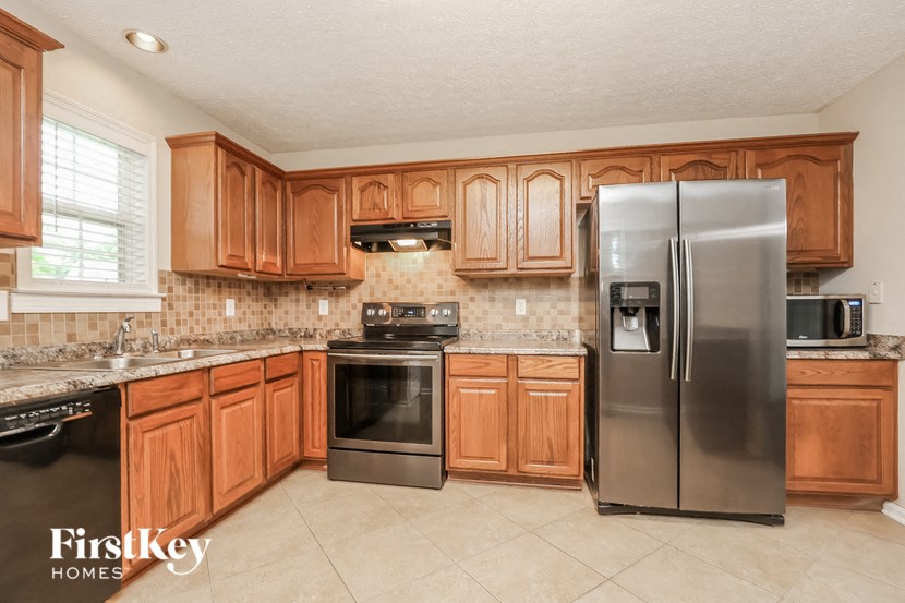 a kitchen with wooden cabinets and stainless steel appliances