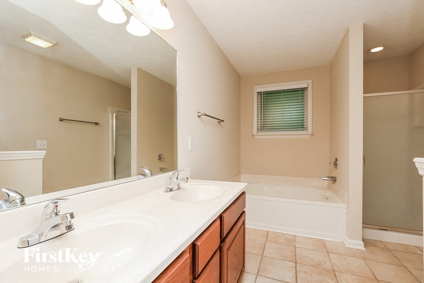 a bathroom with a sink and a tub and a mirror