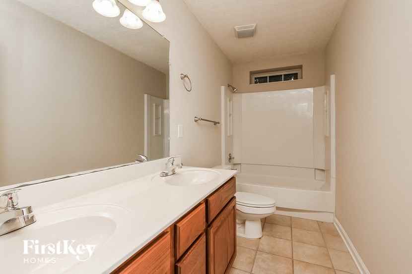a bathroom with a sink and a toilet and a shower