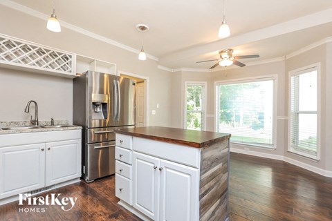 a kitchen with white cabinets and a counter top