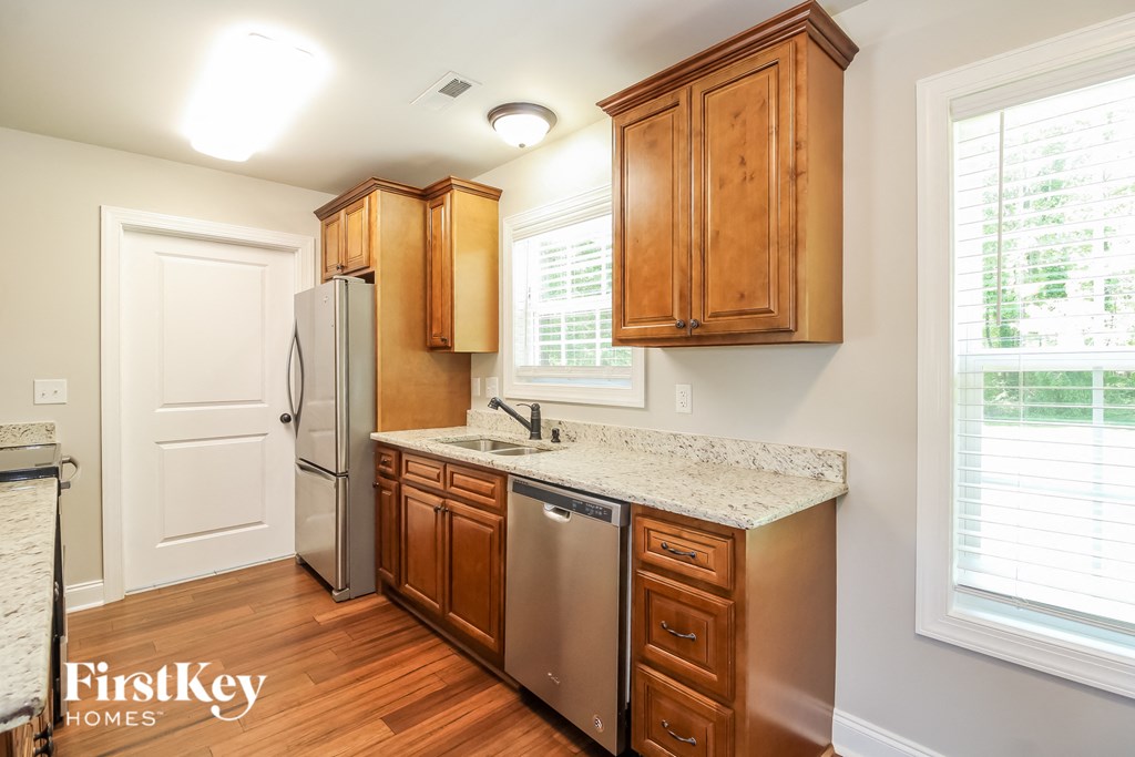 A kitchen with wooden cabinets and stainless steel appliances.