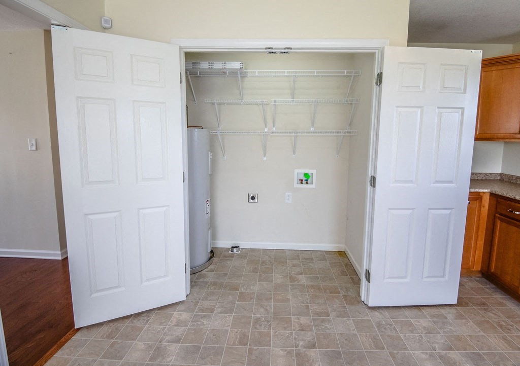 a room with two closets and a refrigerator in it