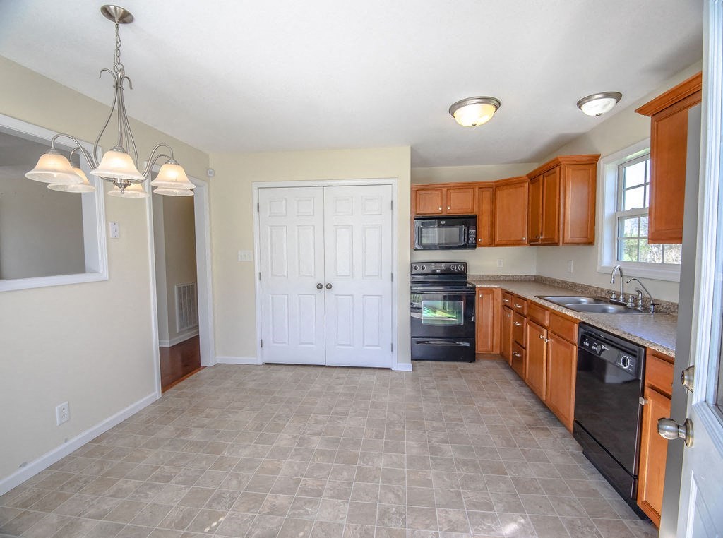 an empty kitchen with a door to the living room