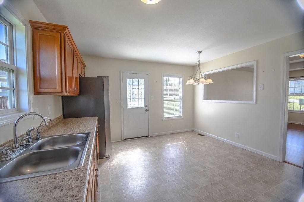 an empty kitchen and living room with a sink