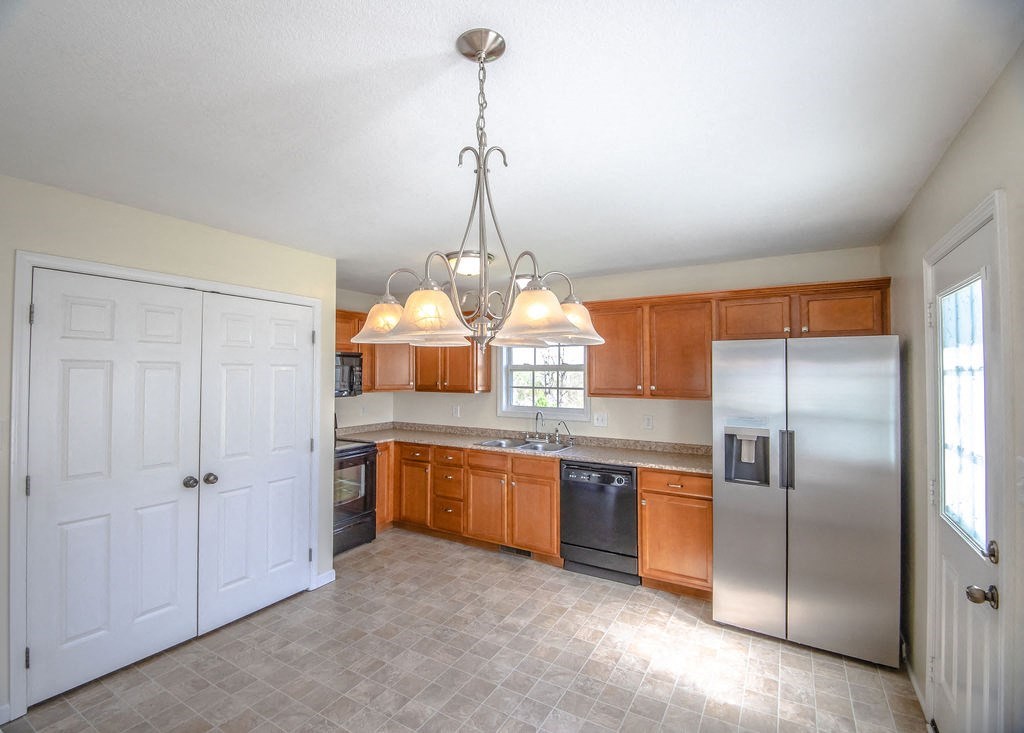 a kitchen with stainless steel appliances and wooden cabinets