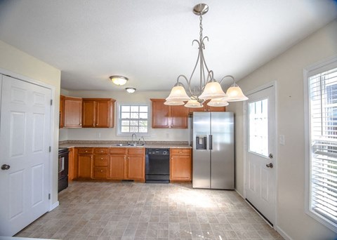 a kitchen with stainless steel appliances and wooden cabinets