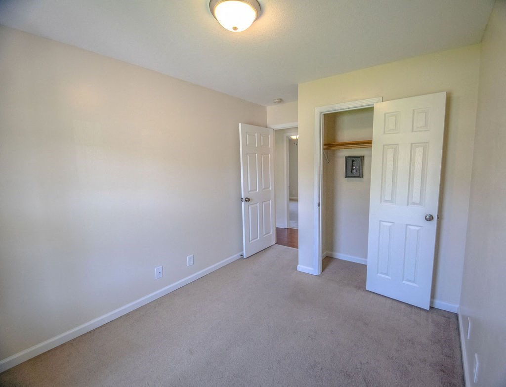 a room with a carpeted floor and a white door