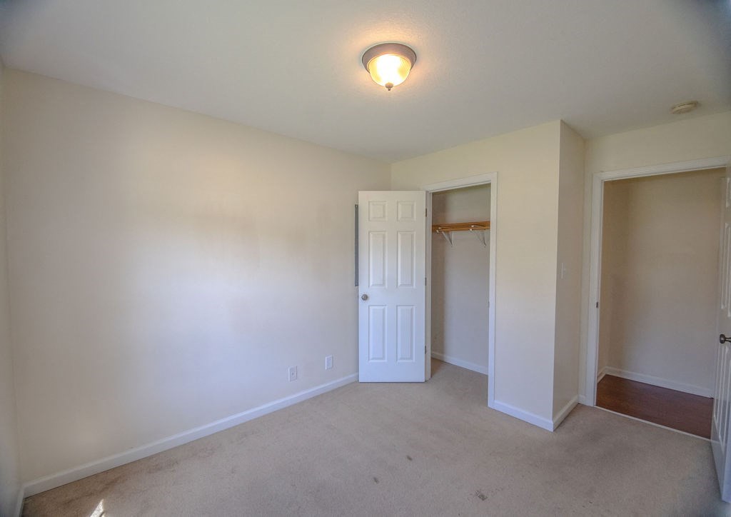 a living room with a door to a closet