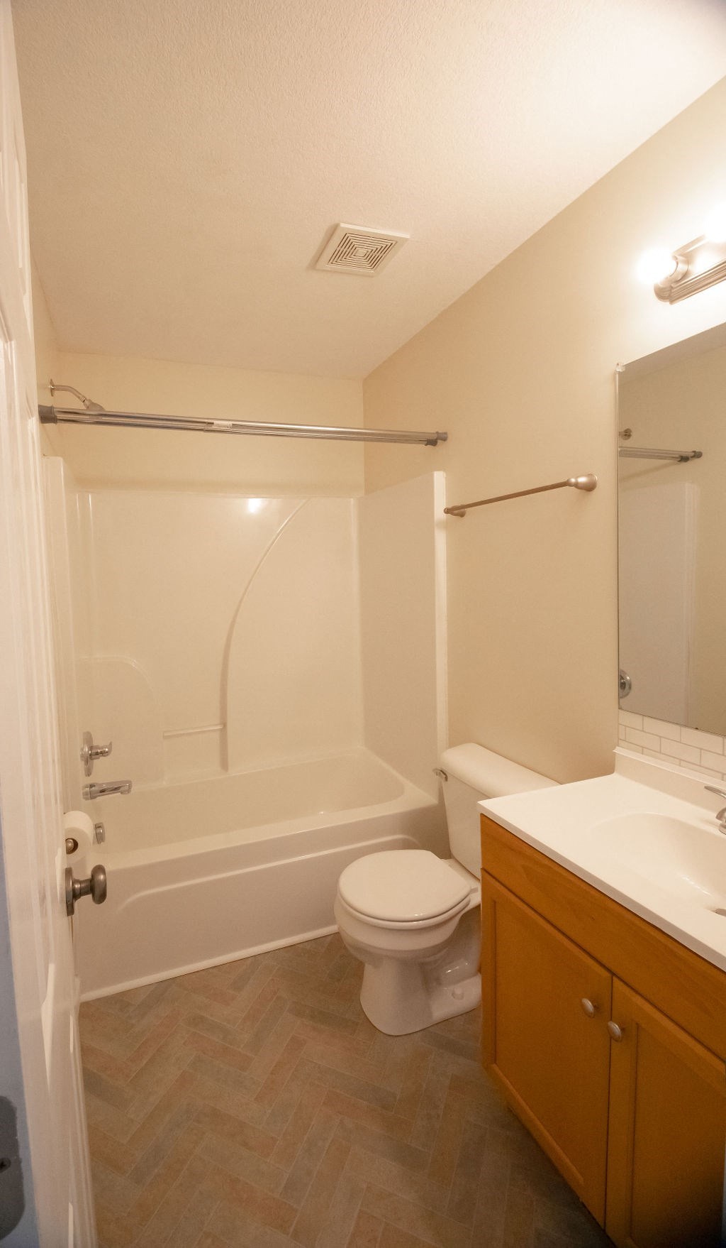 a bathroom with a toilet and a tub and a sink