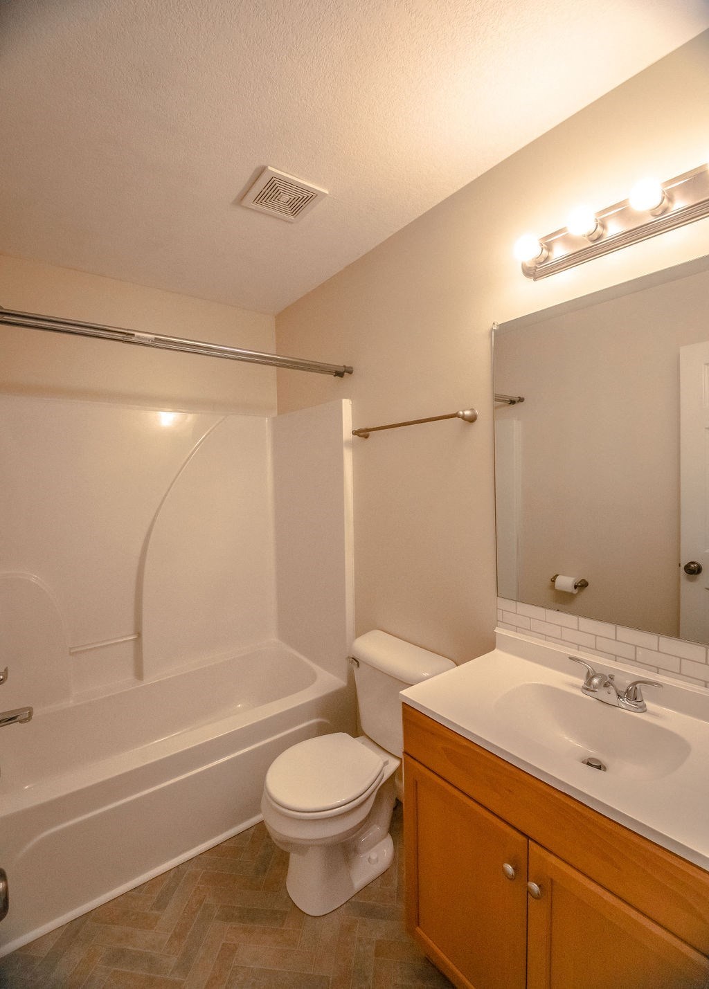 a bathroom with a toilet and a tub and a sink