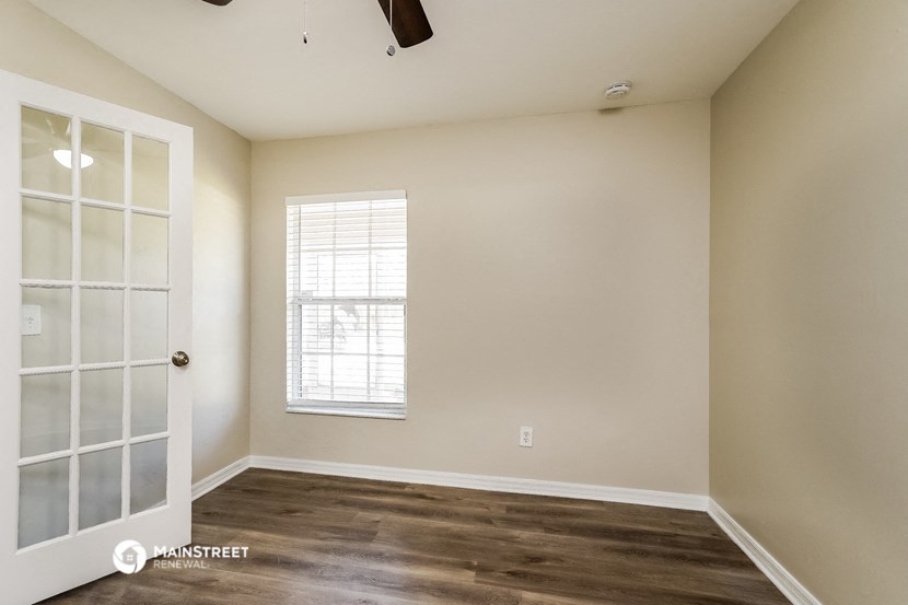 an empty room with a door and a window