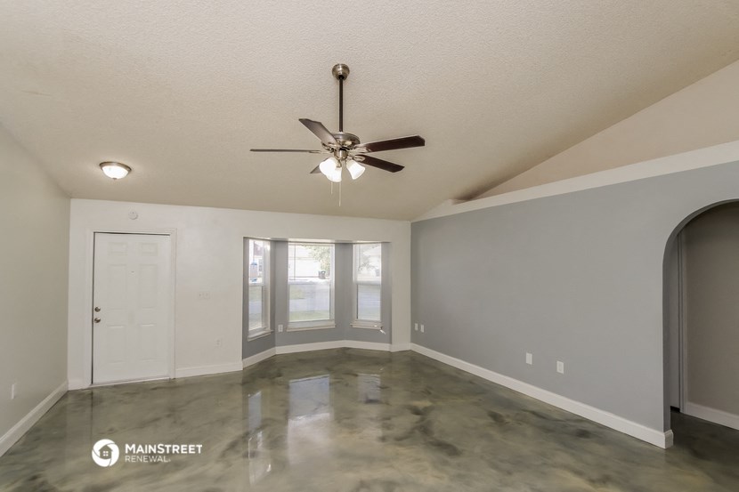 the 2400 bonus room has a large window and a ceiling fan