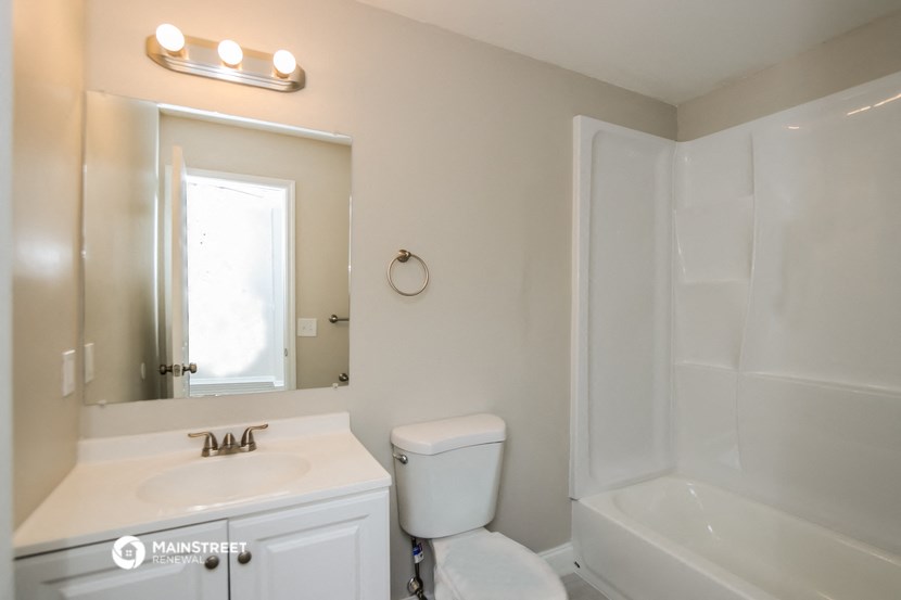 a small bathroom with a sink toilet and shower