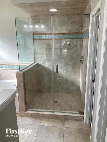 a bathroom with a shower with a glass door