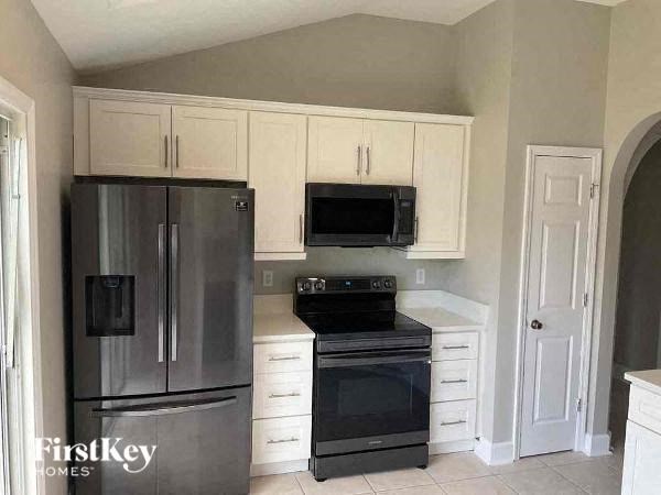 a kitchen with stainless steel appliances and white cabinets