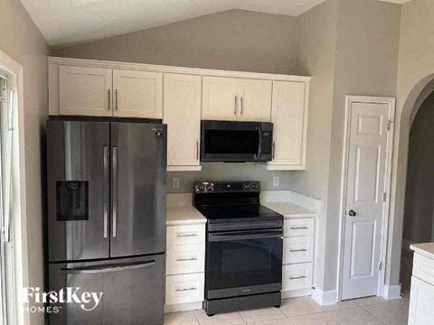 a kitchen with stainless steel appliances and white cabinets