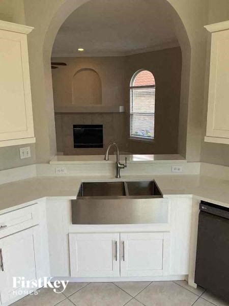 a kitchen with white cabinets and a sink