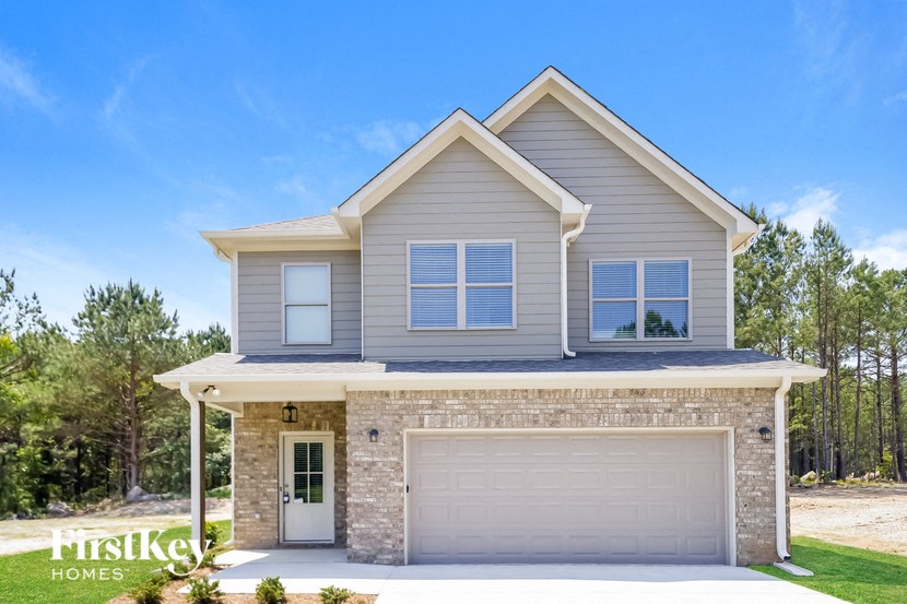 a house with a garage door in front of it