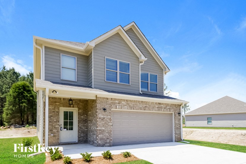 a house with a garage door in front of it