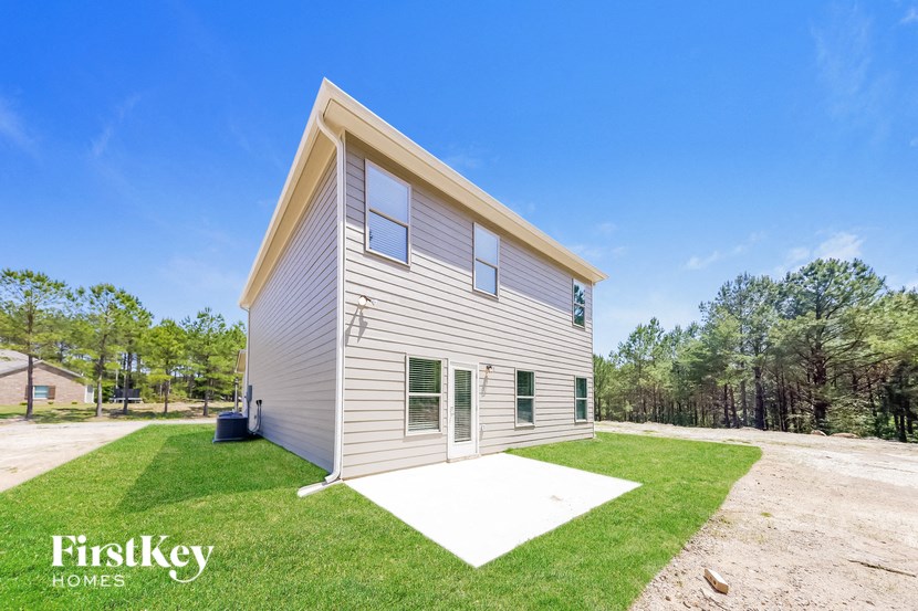 a small house with a yard and a driveway