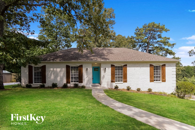 a white house with a blue front door and a green lawn