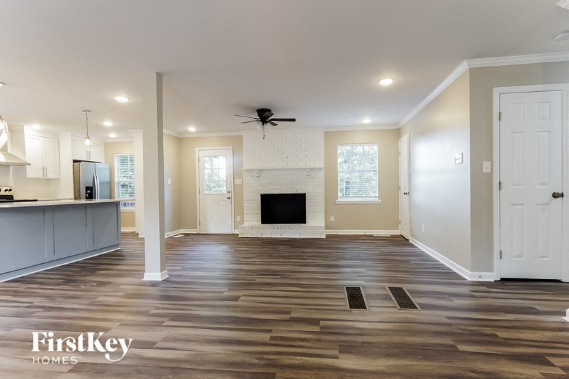 a kitchen and living room with wood floors and a fireplace