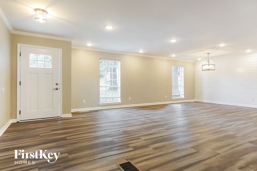 the living room with hardwood floors and a white door