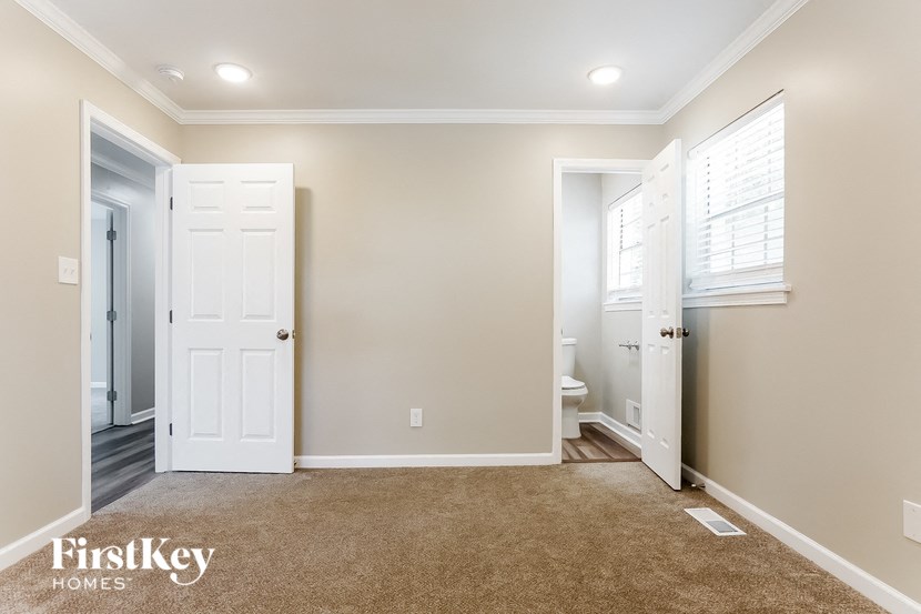 a master bedroom with a closet and a door to a bathroom