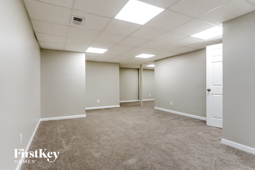 an empty room with a carpeted floor and white walls