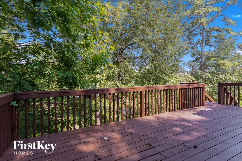 a deck with a view of trees and a blue sky