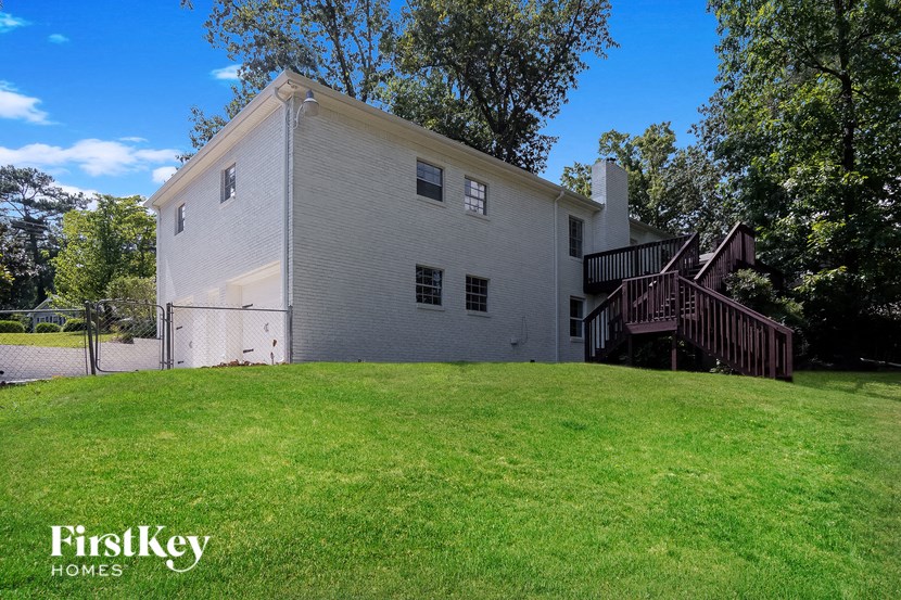 a large white house with a yard in front of it