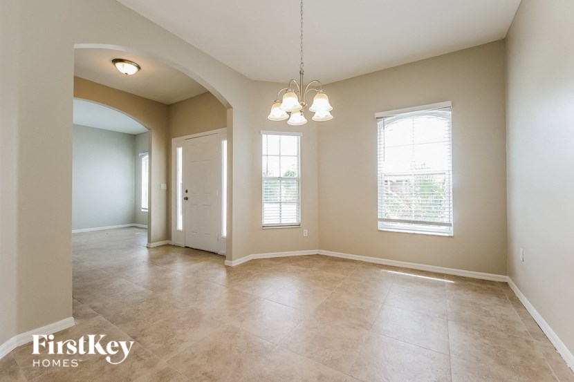 an empty living room with a door and a window