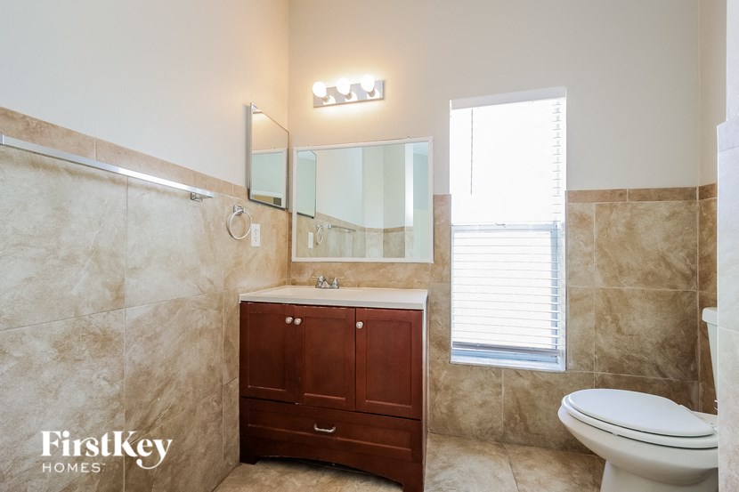 a bathroom with a toilet sink and a mirror
