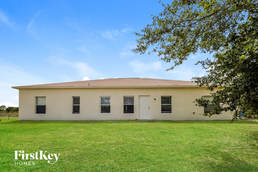 an old with a green lawn and a tree