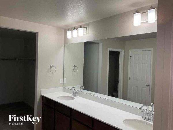 a bathroom with two sinks and a large mirror