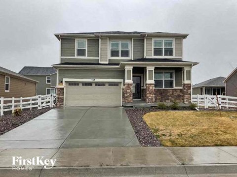 a two story house with a garage door